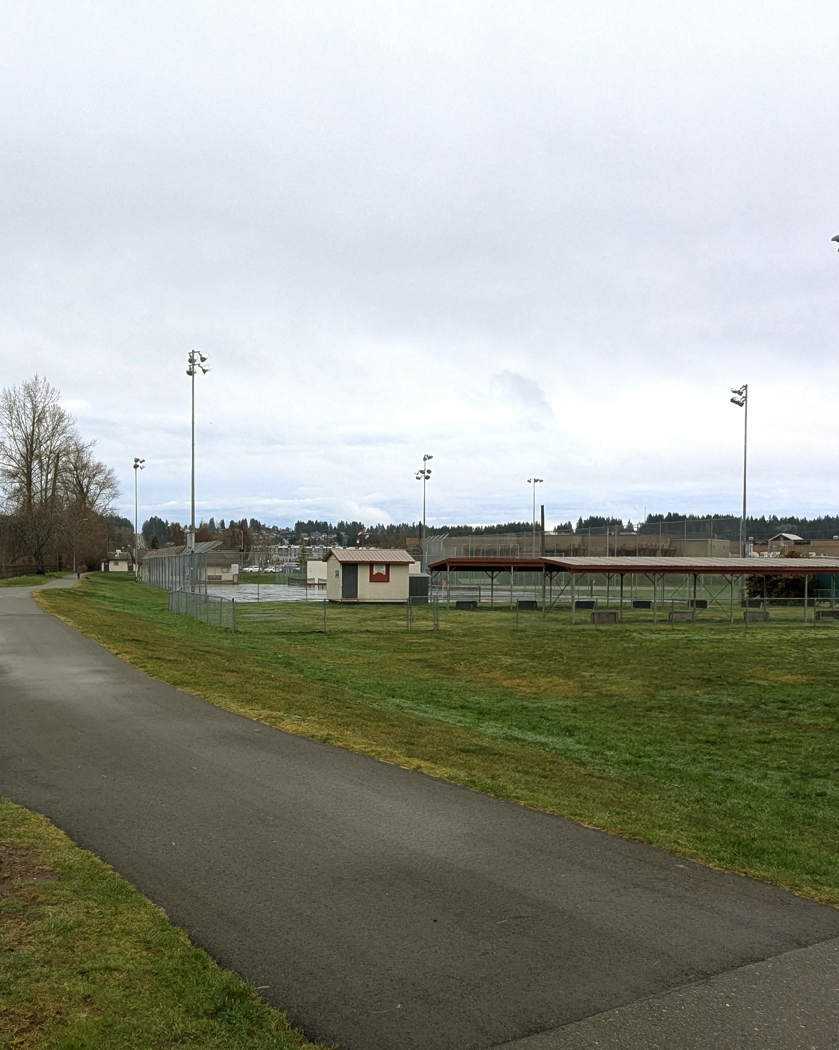 bike path and green grass with small out-building and lawn bowling course